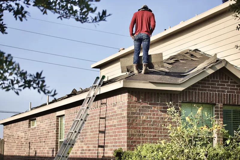 Professional roofer working on a residential roof in Virginia Footills